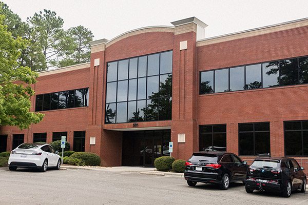 Business Insurers of the Carolinas - View of Office Building and Parking Lot with Cars in Chapel Hill, NC